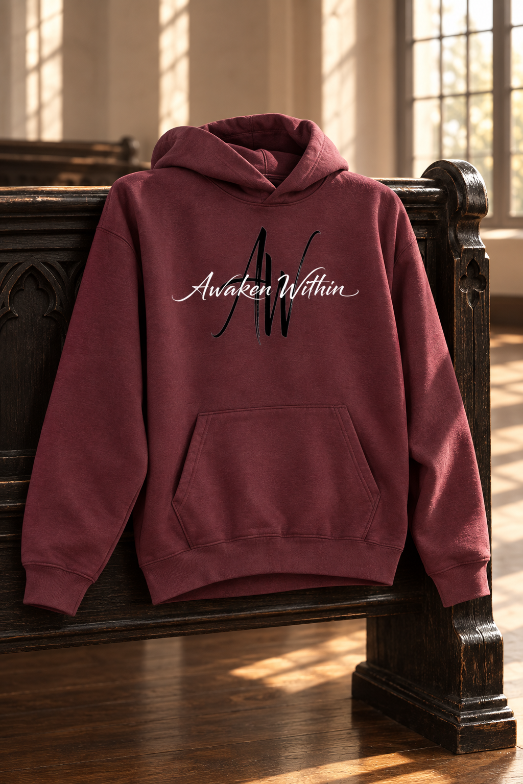 Deep wine AWA hoodie on carved church pew