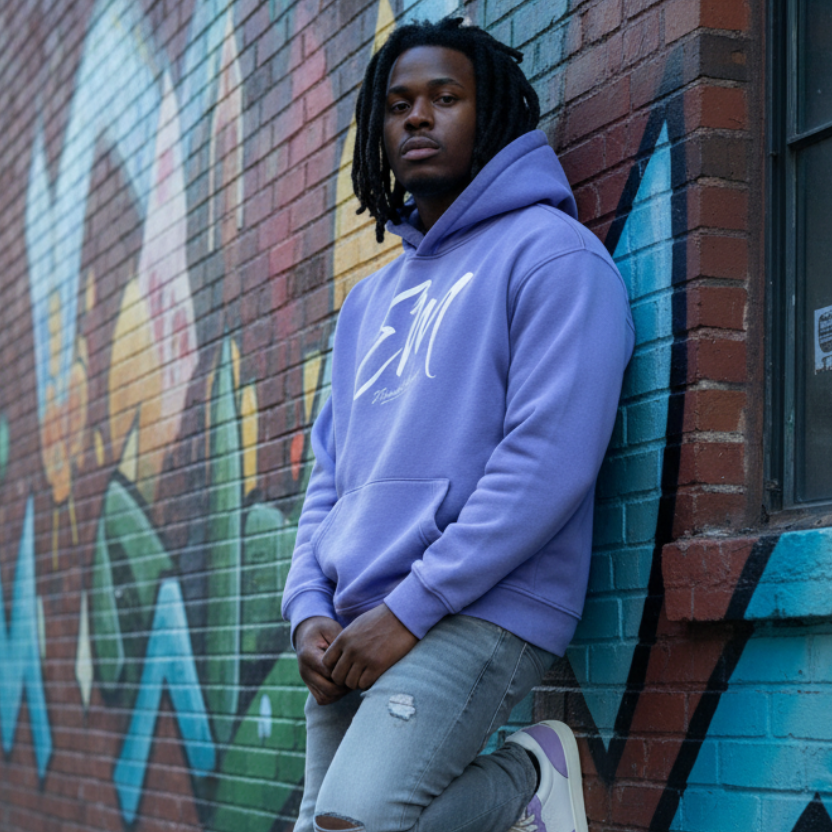 Male model in lavender EM hoodie with Coach sneakers