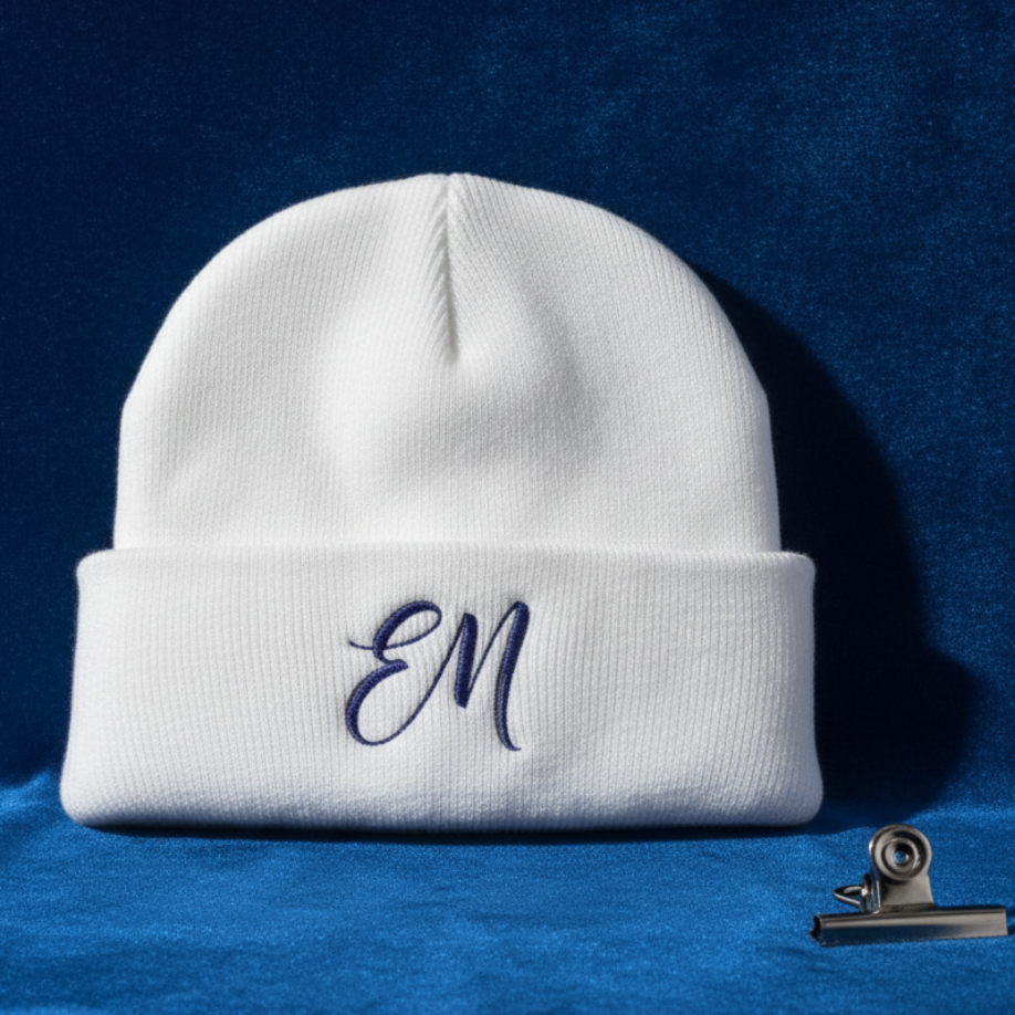 White Elevated Minds beanie folded on cobalt velvet